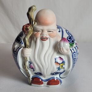 Ceramic Figurine with Blue and Red Accents